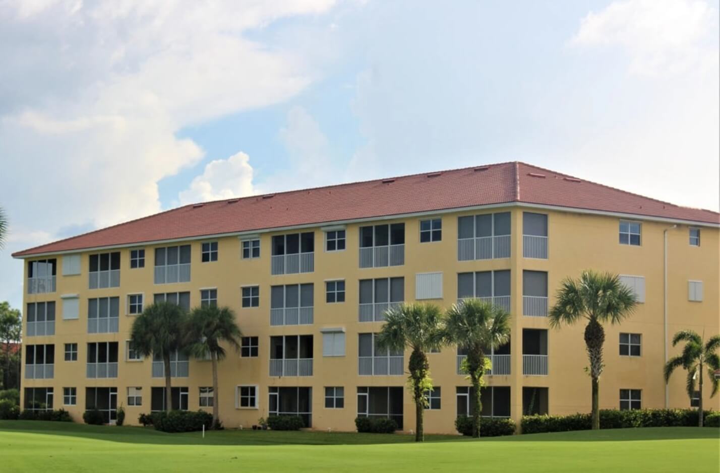 Red Tile roof on a large, yellow apartment building in Southwest Florida