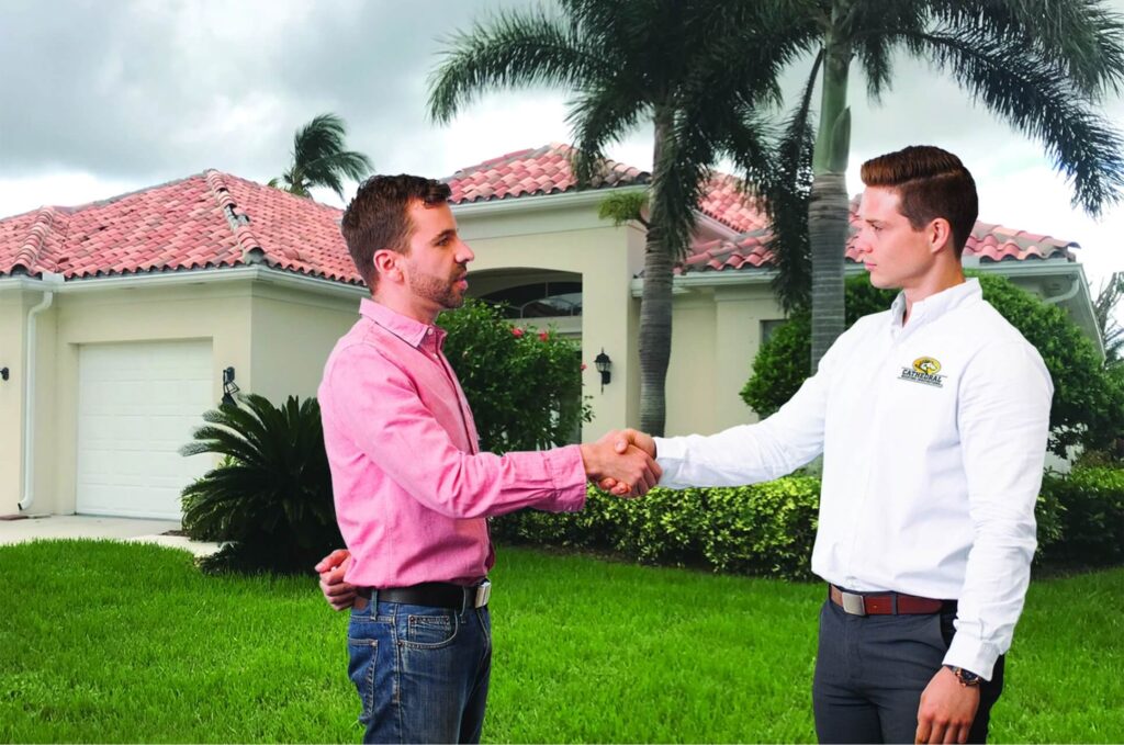 Cathedral Roofing Representative (Right) closes a deal with a homeowner (left) 