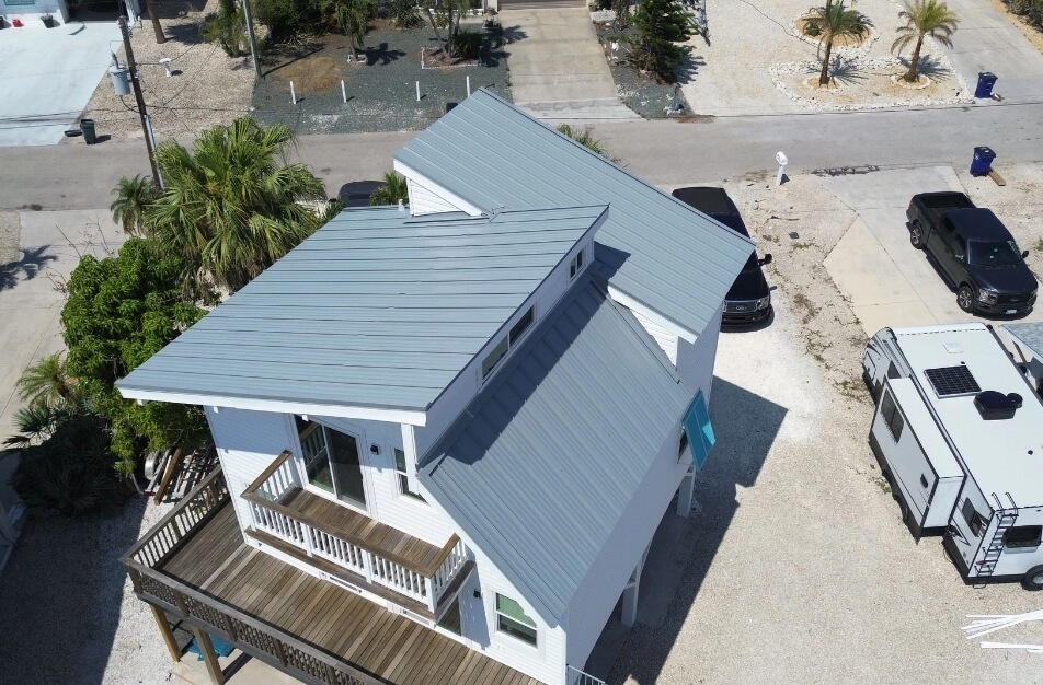 Back of home with new metal roof installed by Cathedral Roofing. Photo taken by drone